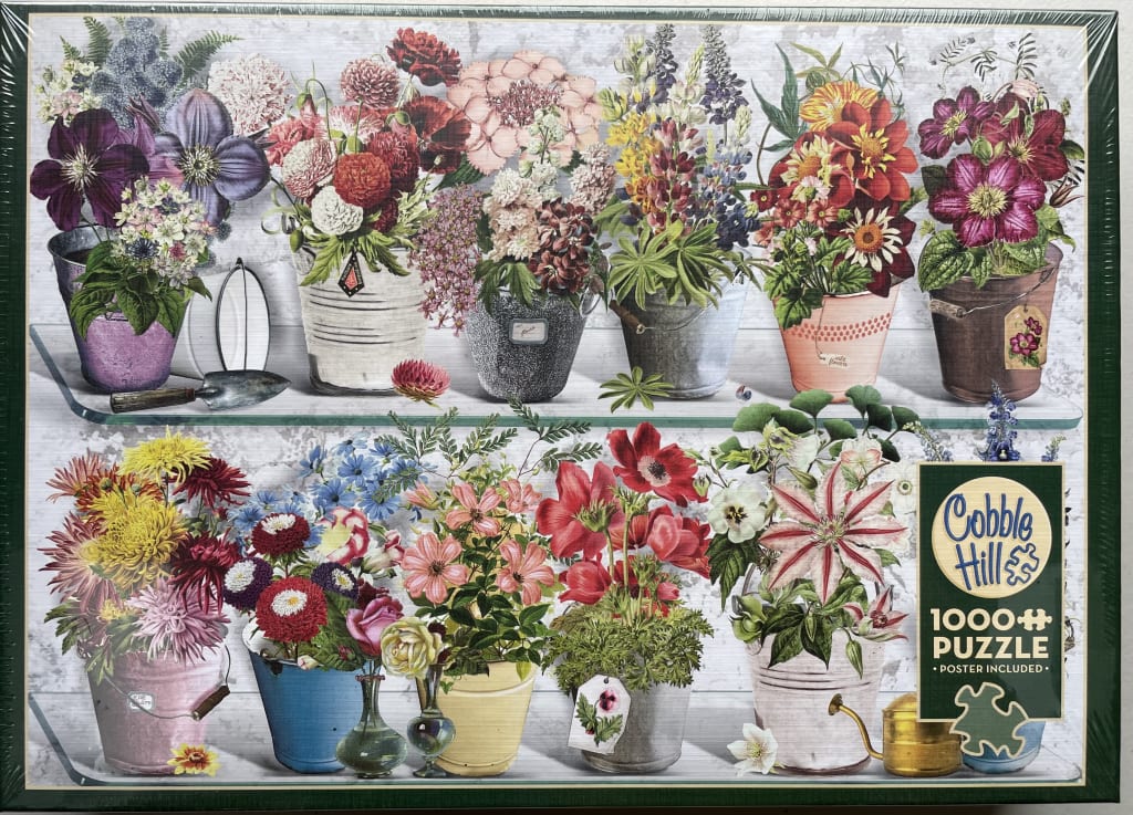 A collection of floral arrangements in rustic buckets and pots displayed on two shelves against a grey wood background.