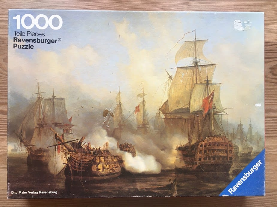 A maritime oil painting depicting a naval battle between wooden sailing ships amidst smoke and hazy light.