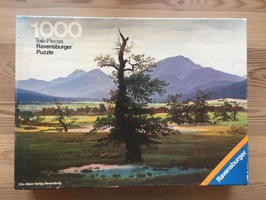 A romantic landscape painting featuring a large solitary oak tree in a meadow with mountains in the background.