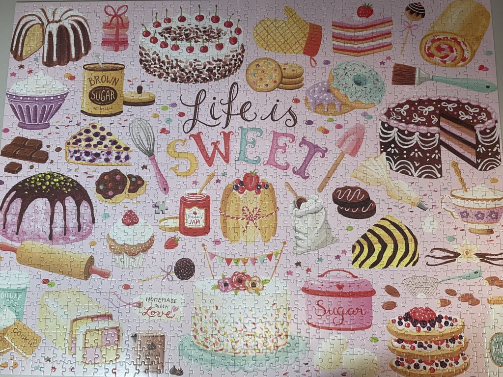 A whimsical illustration of various baked goods and kitchen tools with the text Life is Sweet.