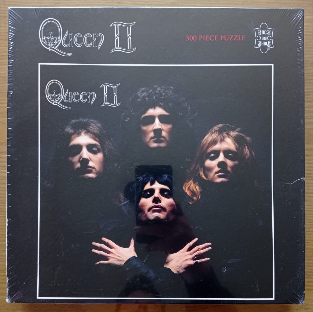 Iconic photographic portrait of the band Queen from the Queen II album cover against a black background.