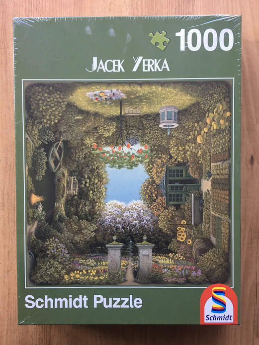 Surreal illustration of a garden folded into a square, featuring a picnic area, gazebo, and blooming flower beds.