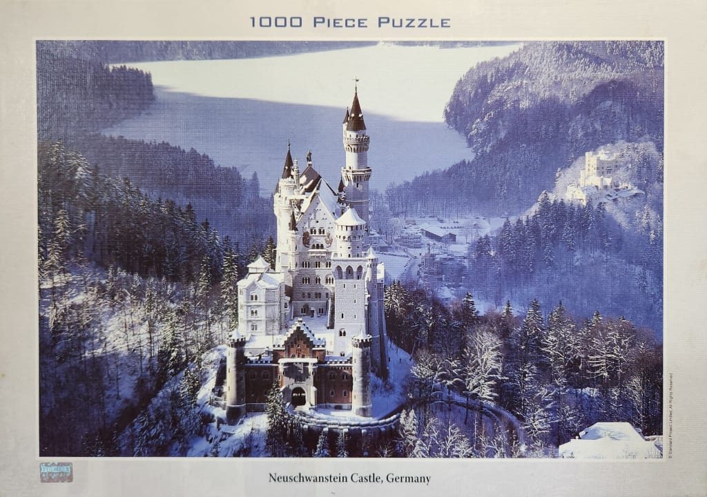 Neuschwanstein Castle surrounded by a snow-covered winter forest