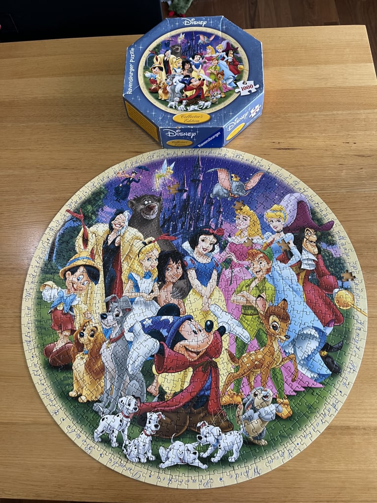 A circular illustration featuring a crowded gathering of many iconic Disney characters in front of a dark castle.