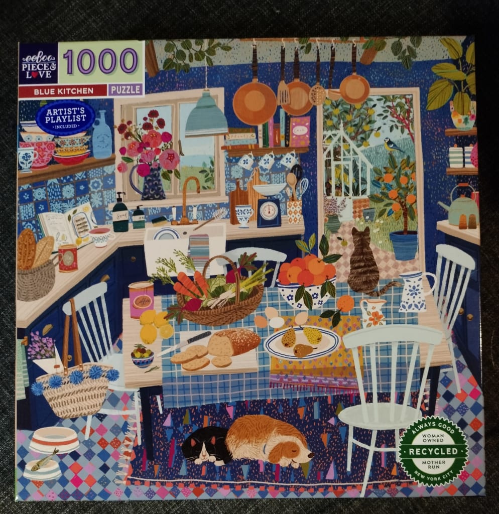 An illustration of a cozy blue kitchen featuring a dining table, a pet cat and dog, and a view into a sunny garden.