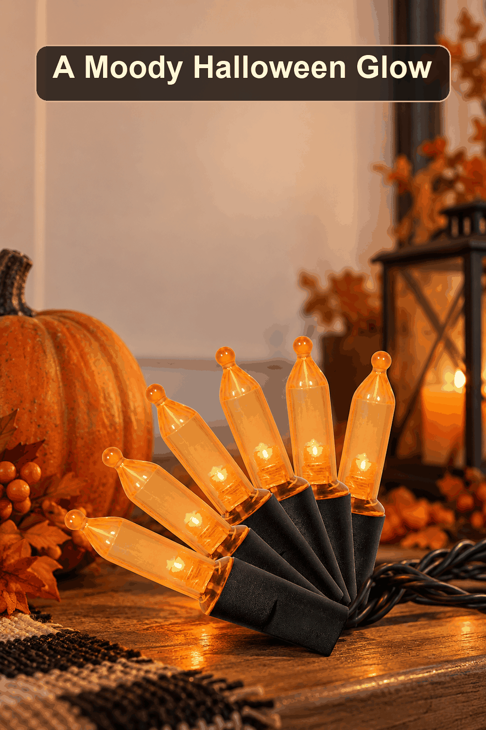 Styled Halloween home scene featuring the 70-Count UL LED Orange Mini Lights, with the words A Moody Halloween Glow in a dark banner above.
