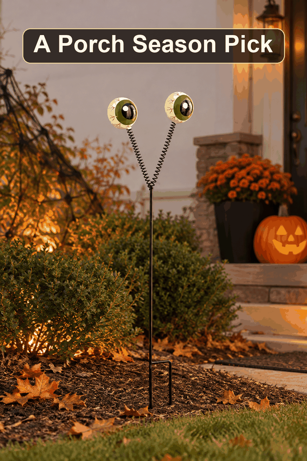 Styled Halloween home scene featuring the Grim Gardens Eyeball Yard Stake, 25.6", with the words A Porch Season Pick in a dark banner above.
