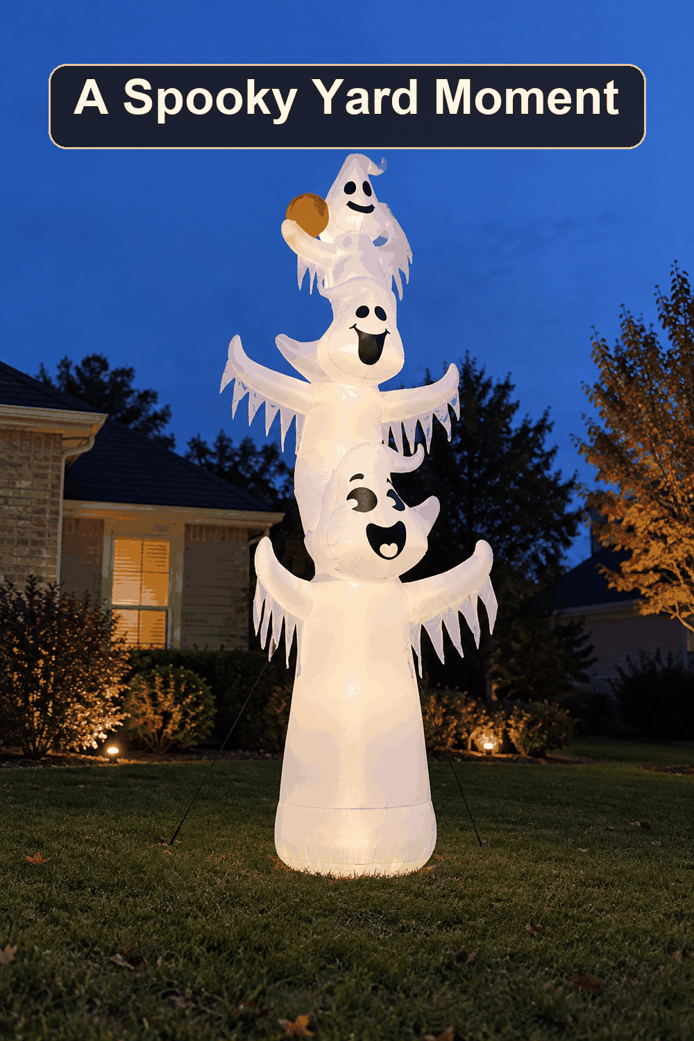 Styled Halloween home scene featuring the 3 Inflatable Ghosts, 12', with the words A Spooky Yard Moment in a dark banner above.
