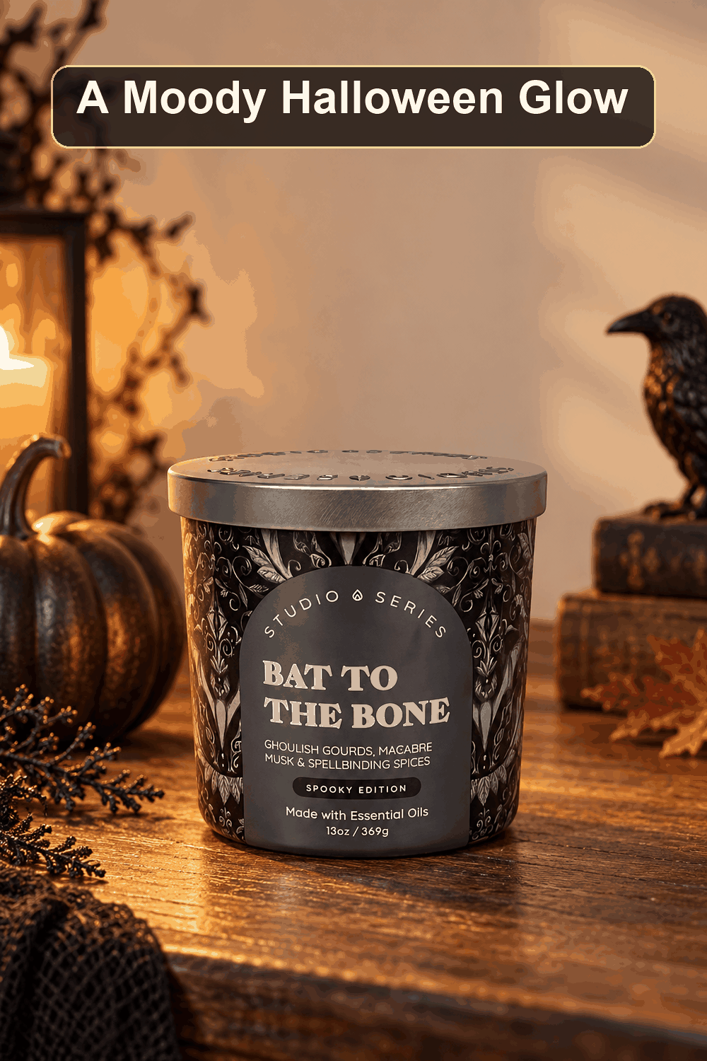 Styled Halloween home scene featuring the Bat to the Bone Scented Jar Candle, 13oz, with the words A Moody Halloween Glow in a dark banner above.