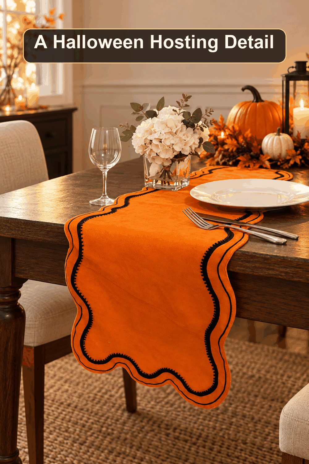 Styled Halloween home scene featuring the Scalloped Orange Velvet Table Runner, with the words A Halloween Hosting Detail in a dark banner above.