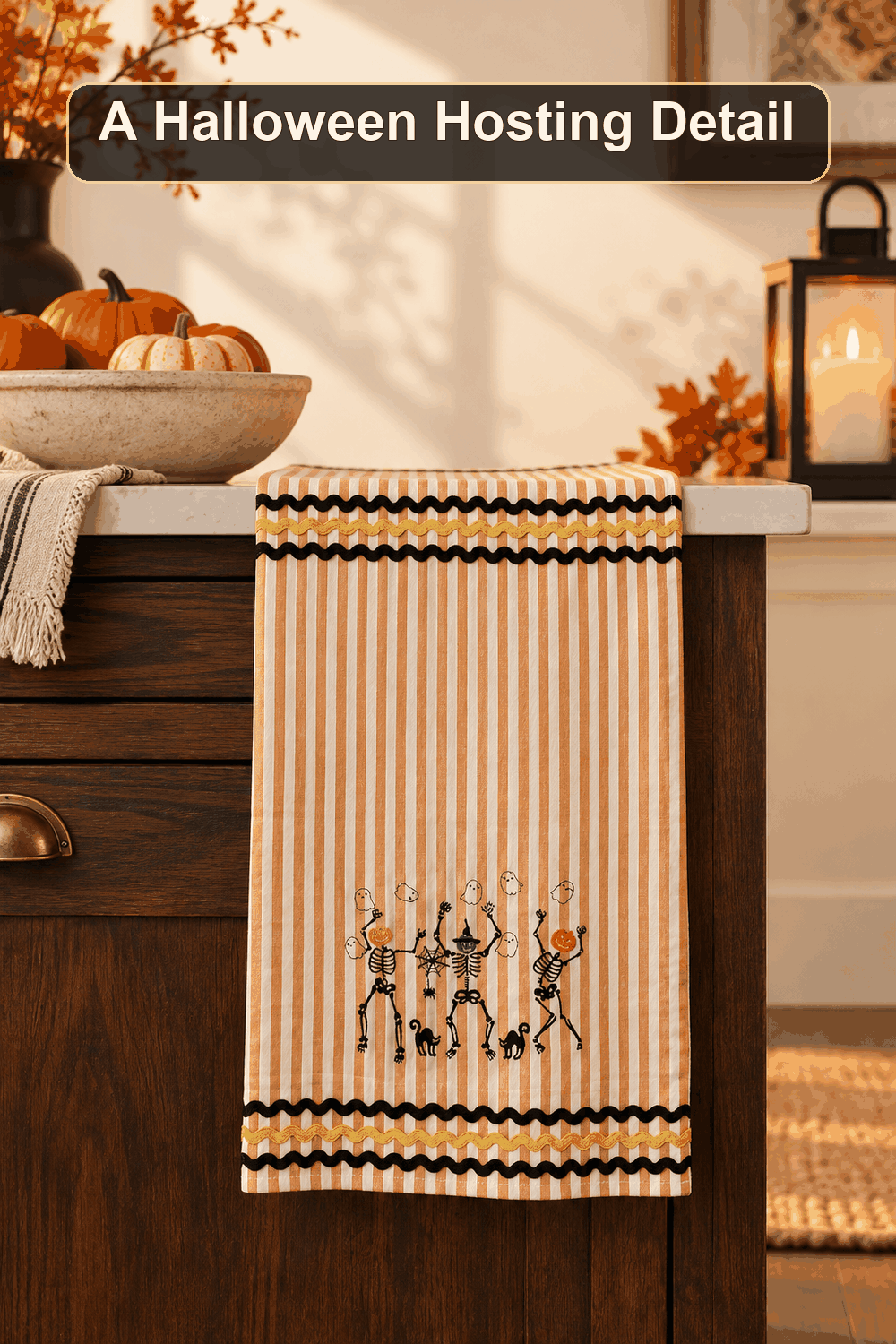 Styled Halloween home scene featuring the Dancing Skeleton Tea Towel, with the words A Halloween Hosting Detail in a dark banner above.