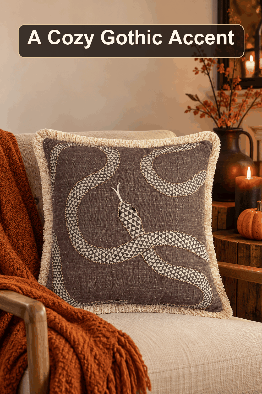 Styled Halloween home scene featuring the Ghost Town Cotton/Linen Blend Snake Throw Pillow with Fringe, 20", with the words A Cozy Gothic Accent in a dark banner above.