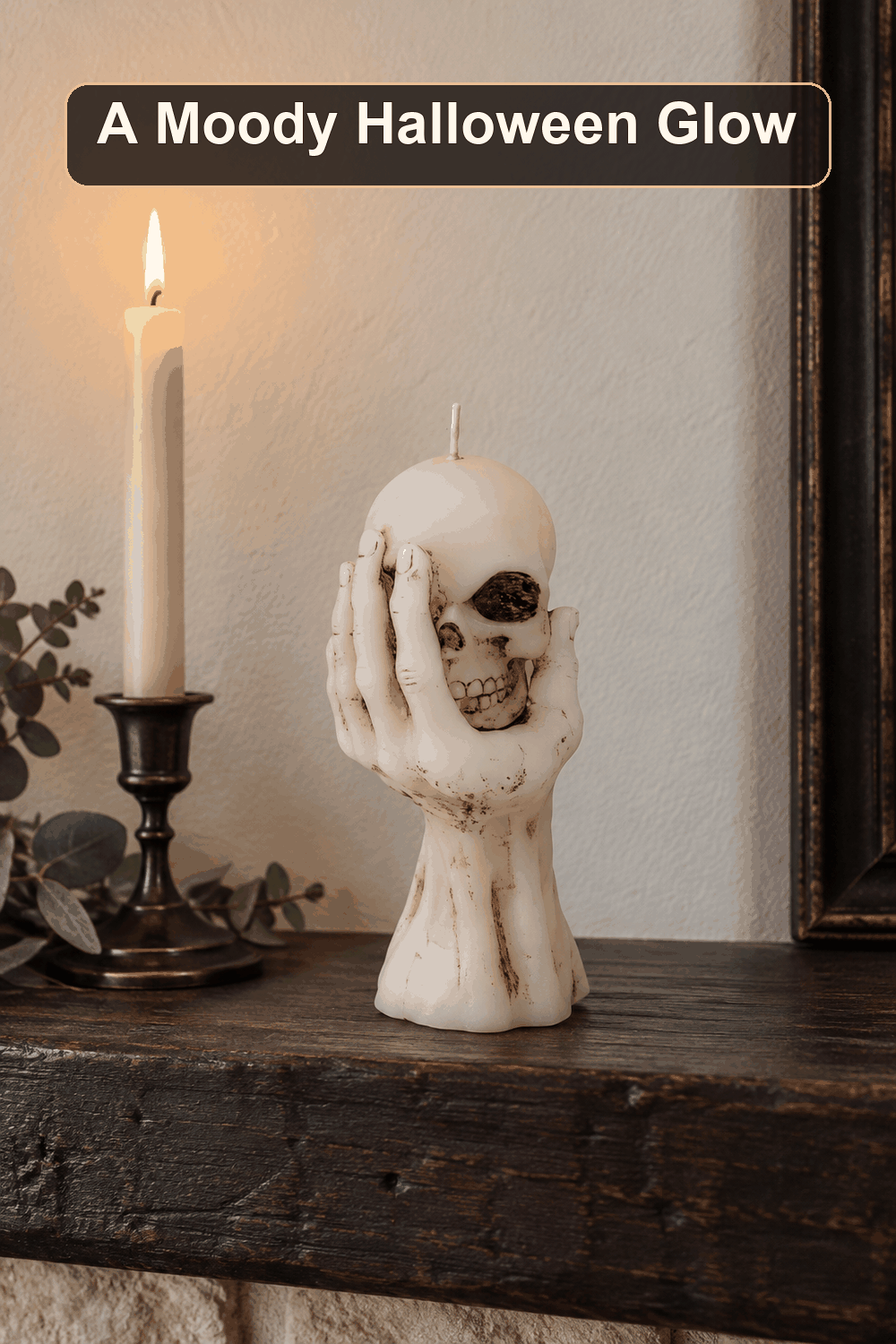 Styled Halloween home scene featuring the Skull in Hand Bleeder Candle, with the words A Moody Halloween Glow in a dark banner above.