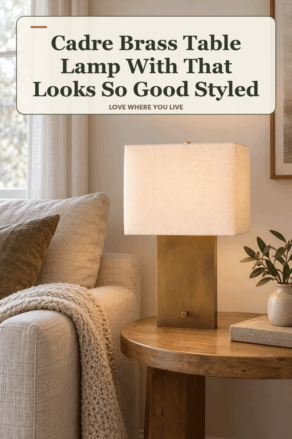 A realistic lived-in home scene featuring the exact Cadre Brass Table Lamp with Fabric Shade, beneath the words Cadre Brass Table Lamp With That Looks So Good Styled.