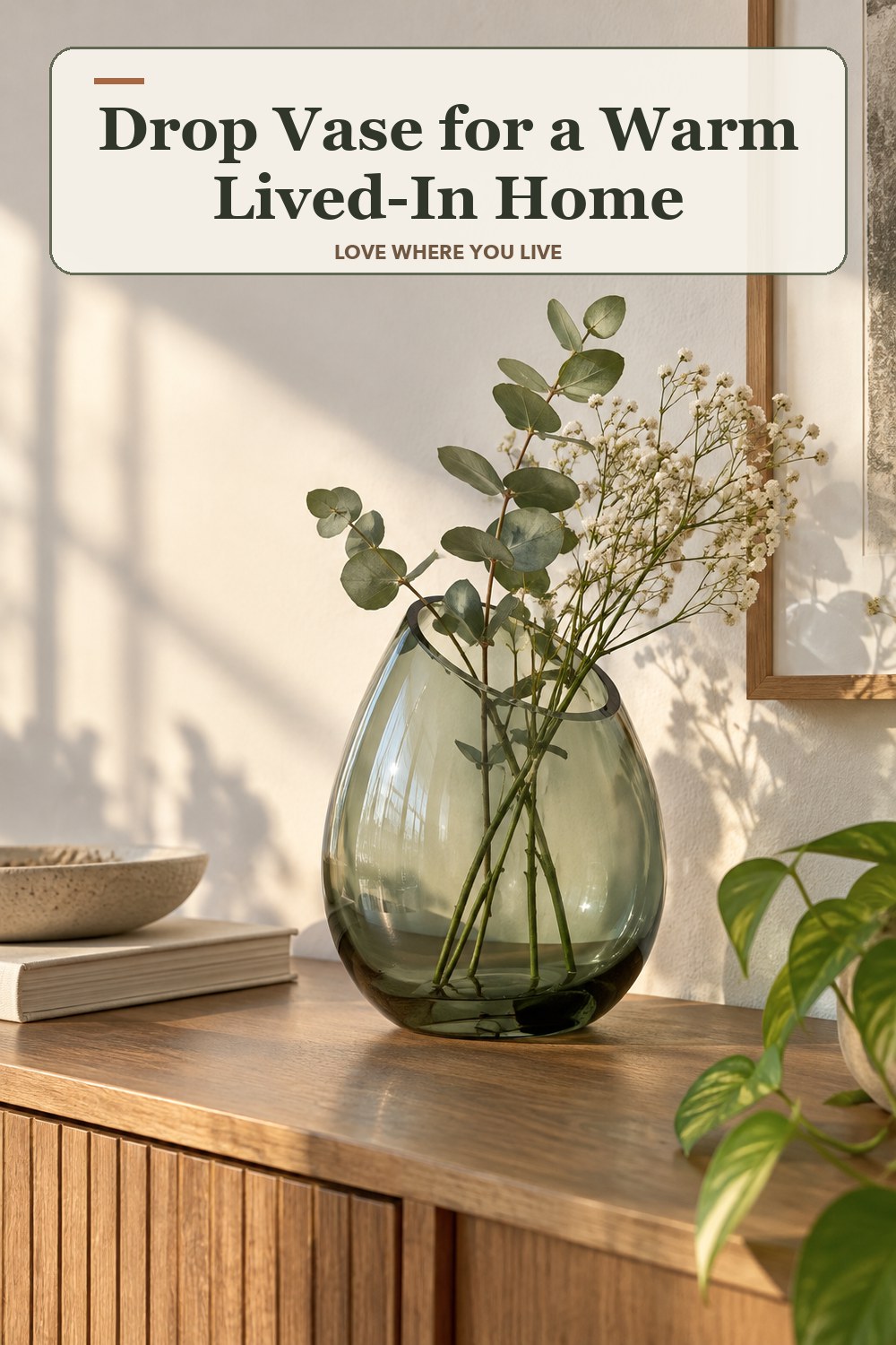 Warm natural-light apartment scene featuring the exact Drop Vase in shown finish, with the headline: Drop Vase for a Warm Lived-In Home.