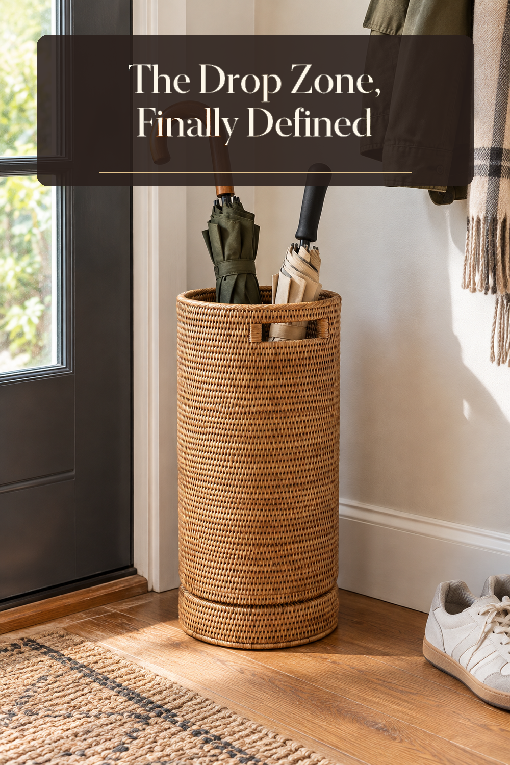 A realistic entryway umbrella stand in use in a naturally lit entryway inside a believable lived-in home.