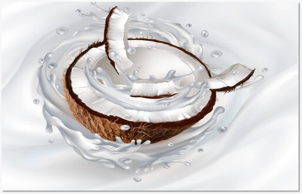 A cracked coconut surrounded by a swirl of milk