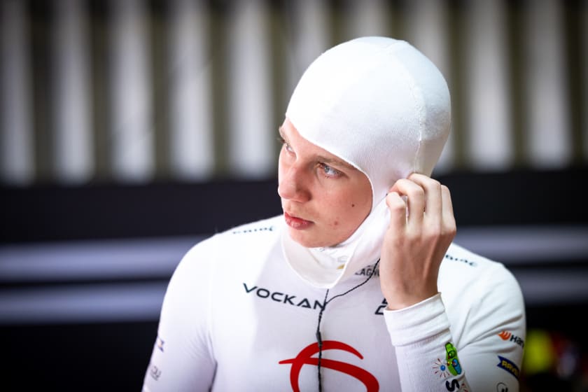 Adjusting the balaclava in the white undersuit