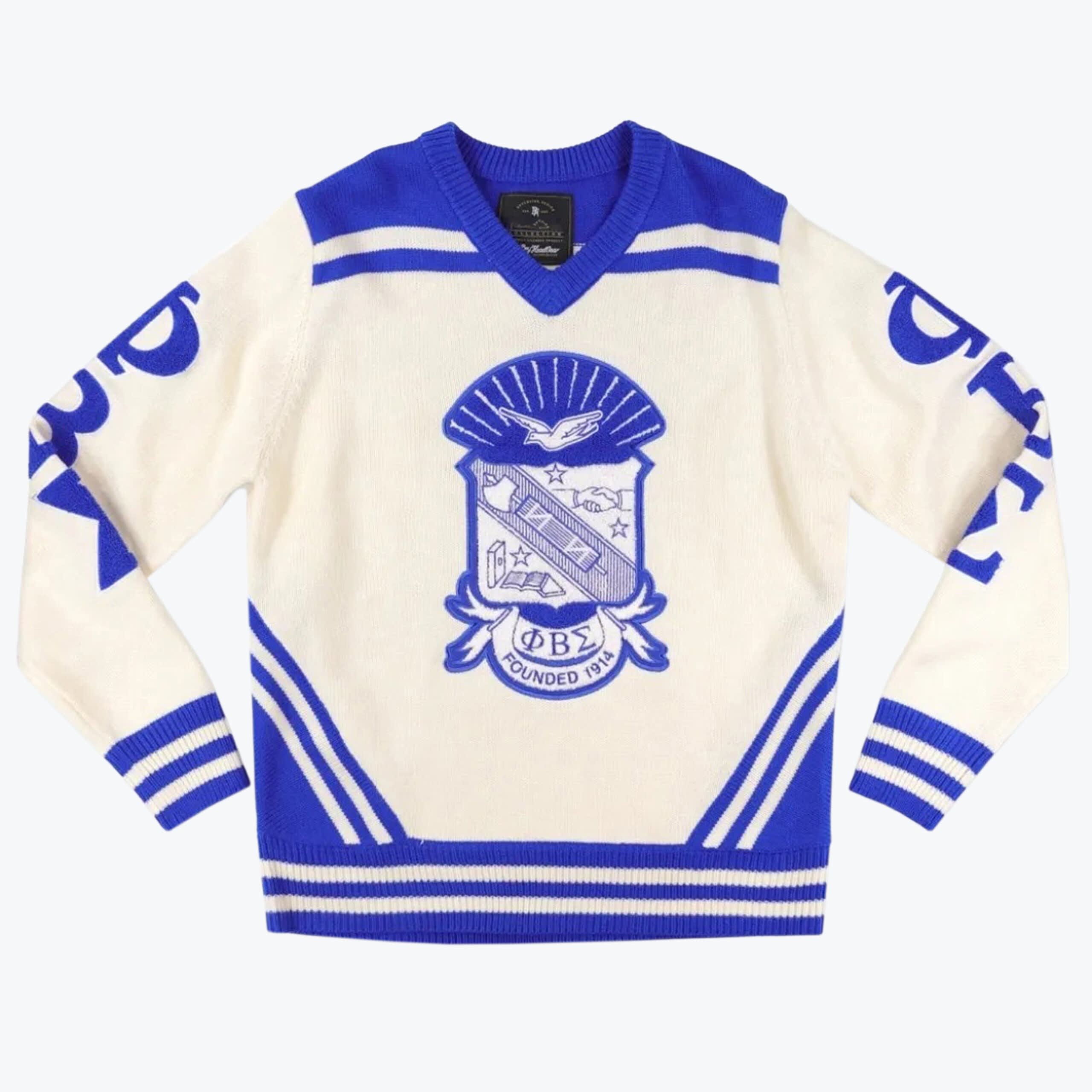 Phi Beta Sigma Fraternity Knit Sweater A cream and royal blue knit v-neck sweater featuring the Phi Beta Sigma fraternity crest on the front and Greek letters on the sleeves.