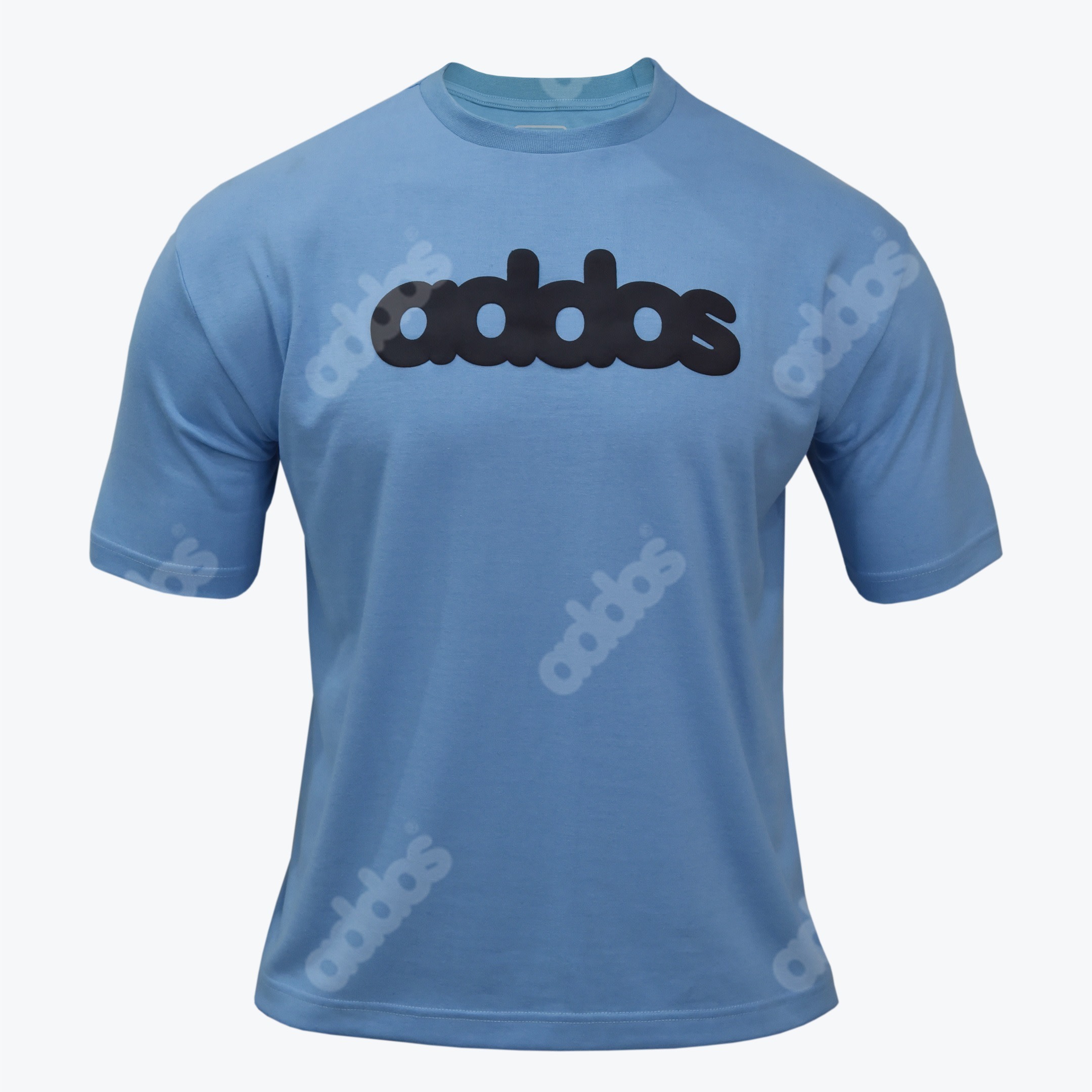 Light Blue Graphic T-Shirt with Stylized Logo A light blue crew neck t shirt with a bold black addas logo on the chest and faint diagonal watermark logos printed on the fabric