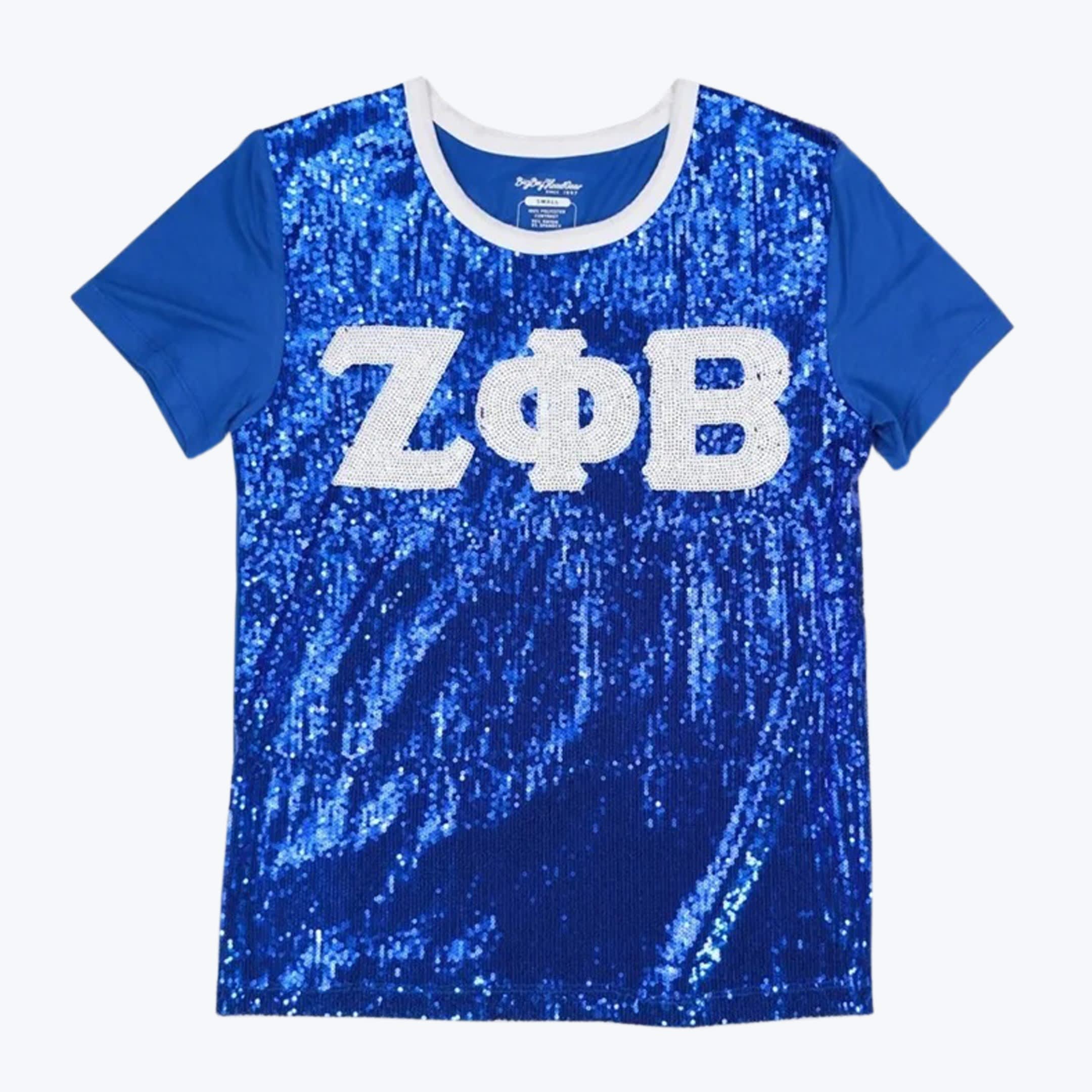 Zeta Phi Beta Royal Blue Sequined T-Shirt A royal blue t-shirt with a shiny sequined front, featuring the Greek letters Z, Phi, and B in white sequins across the chest.