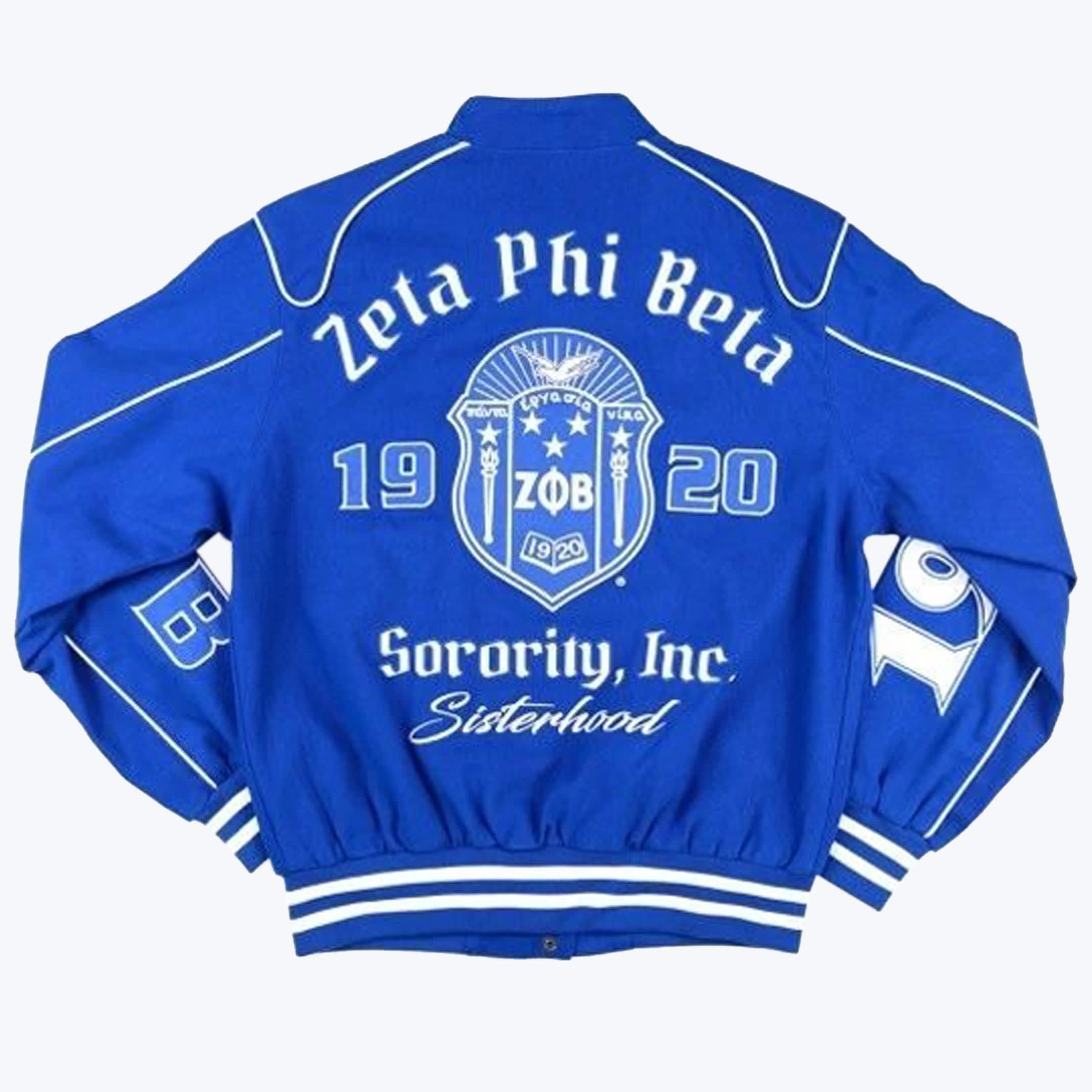 Back view of a royal blue Zeta Phi Beta Sorority varsity jacket with white embroidery showing the sorority name, crest, founding year 1920, and the words 'Sorority, Inc.' and 'Sisterhood'.