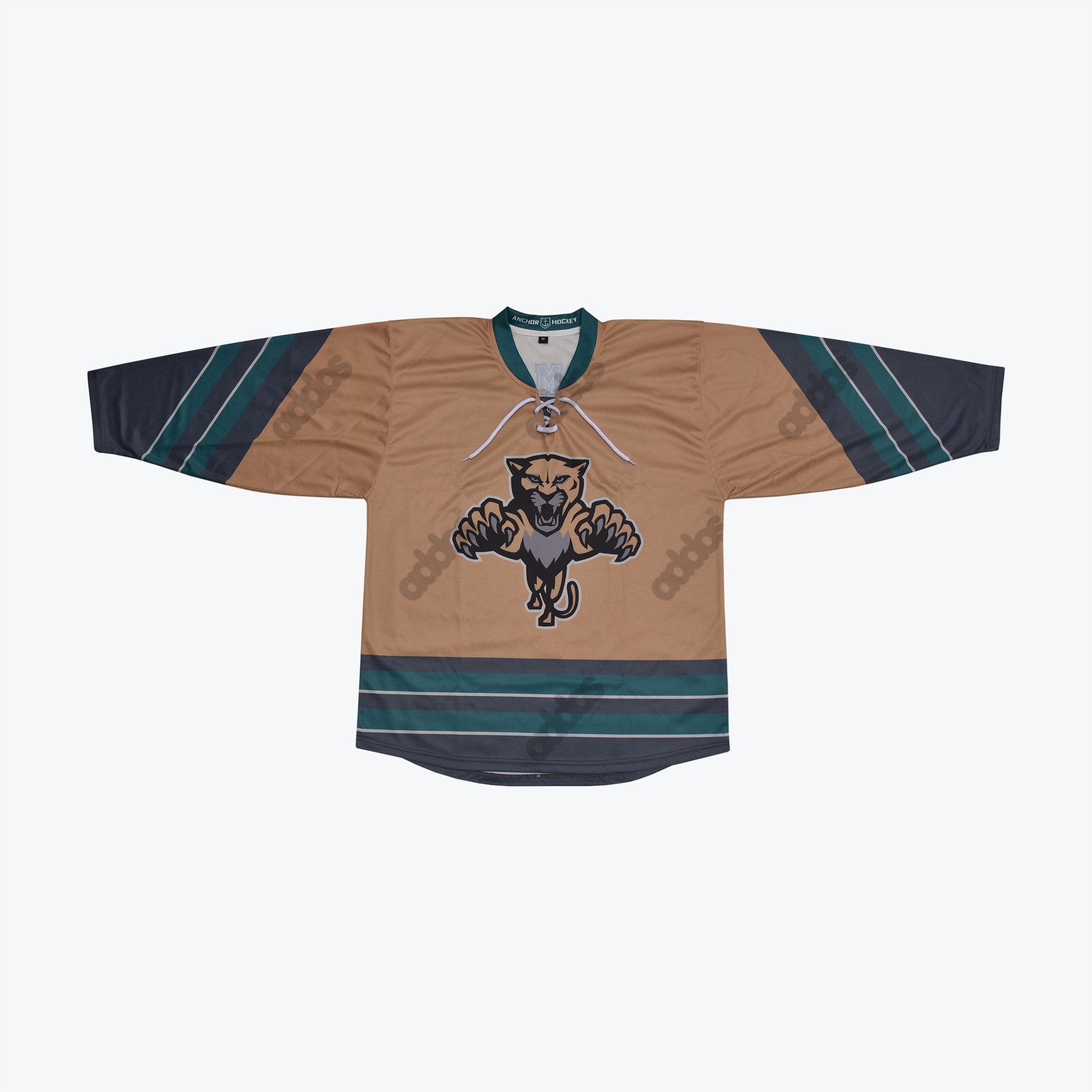 Tan and Teal Panther Hockey Jersey A tan hockey jersey with a leaping panther logo on the chest and teal and grey stripes on the sleeves and hem.