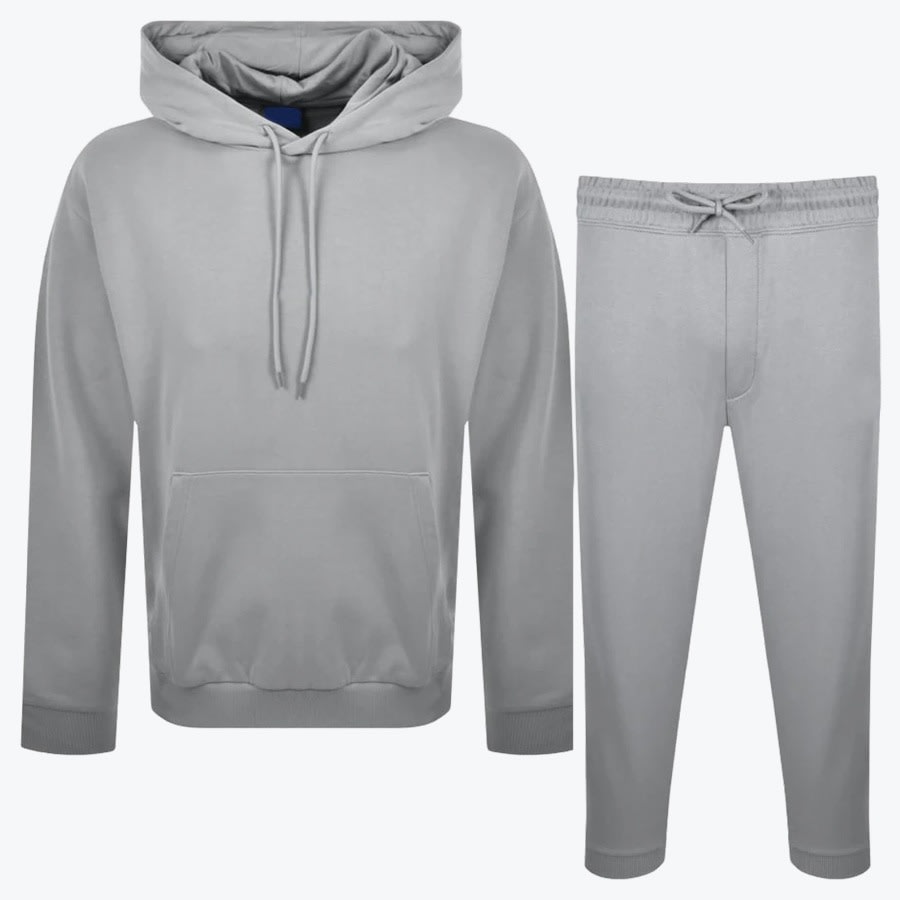 Grey Hoodie and Sweatpants Tracksuit Set A light grey two-piece tracksuit set consisting of a pullover hoodie with a kangaroo pocket and matching drawstring sweatpants, displayed side-by-side on a white background.
