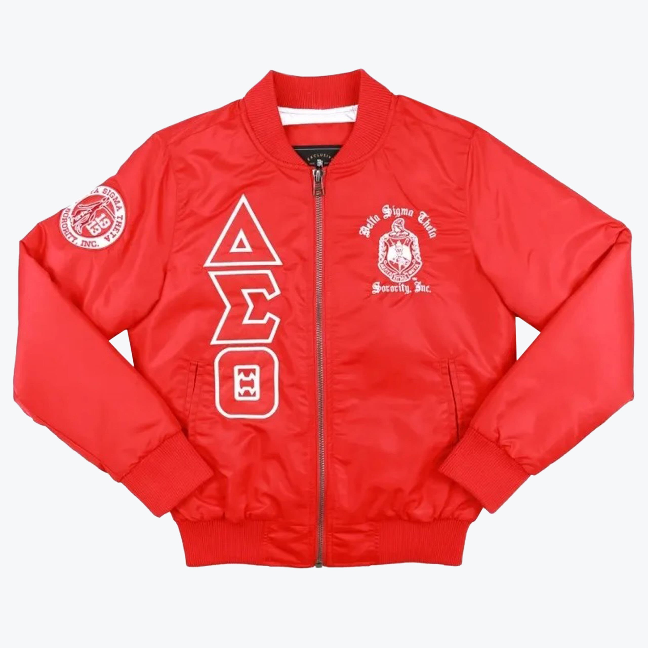 Delta Sigma Theta Red Bomber Jacket A bright red bomber jacket with white Delta Sigma Theta Greek letters vertically on the right chest, the sorority crest on the left chest, and a circular patch on the right sleeve, set against a white background.