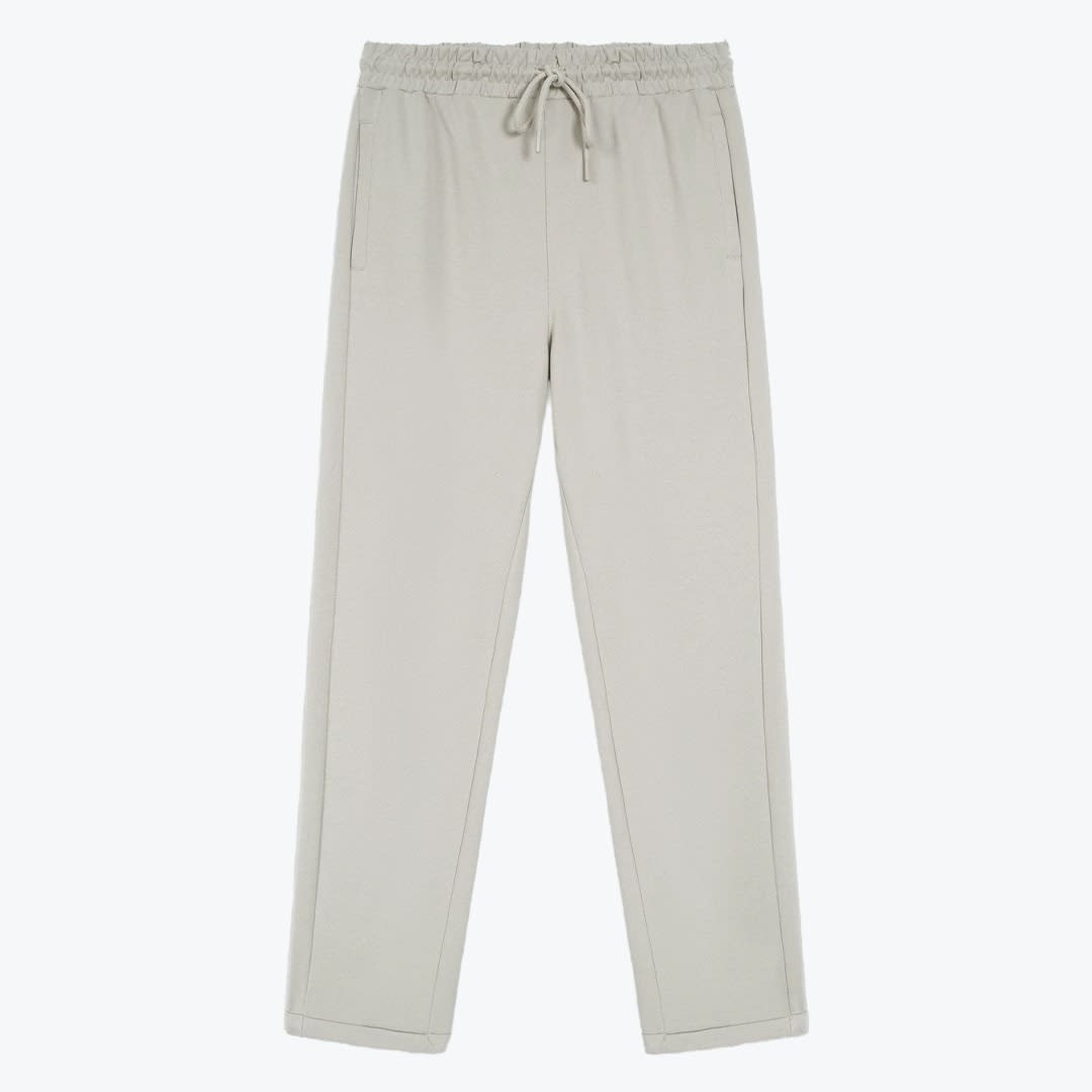 Light Grey Drawstring Sweatpants A front-facing view of a pair of light grey drawstring sweatpants with an elastic waistband against a plain white background.