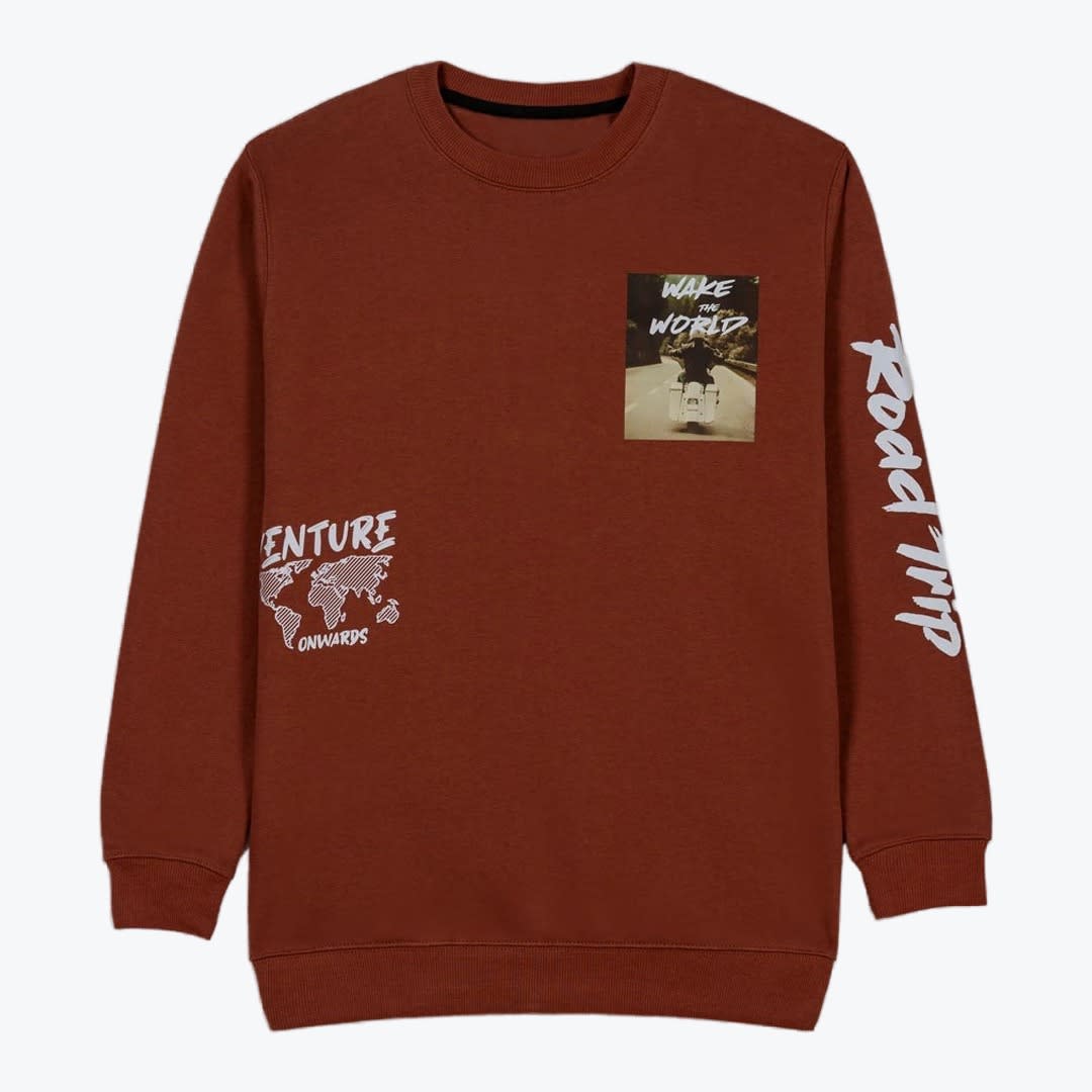 Rust-Brown Adventure Graphic Crewneck Sweatshirt A rust-brown crewneck sweatshirt featuring a motorcycle graphic on the chest, a world map graphic on the lower left, and Road Trip printed on the sleeve.