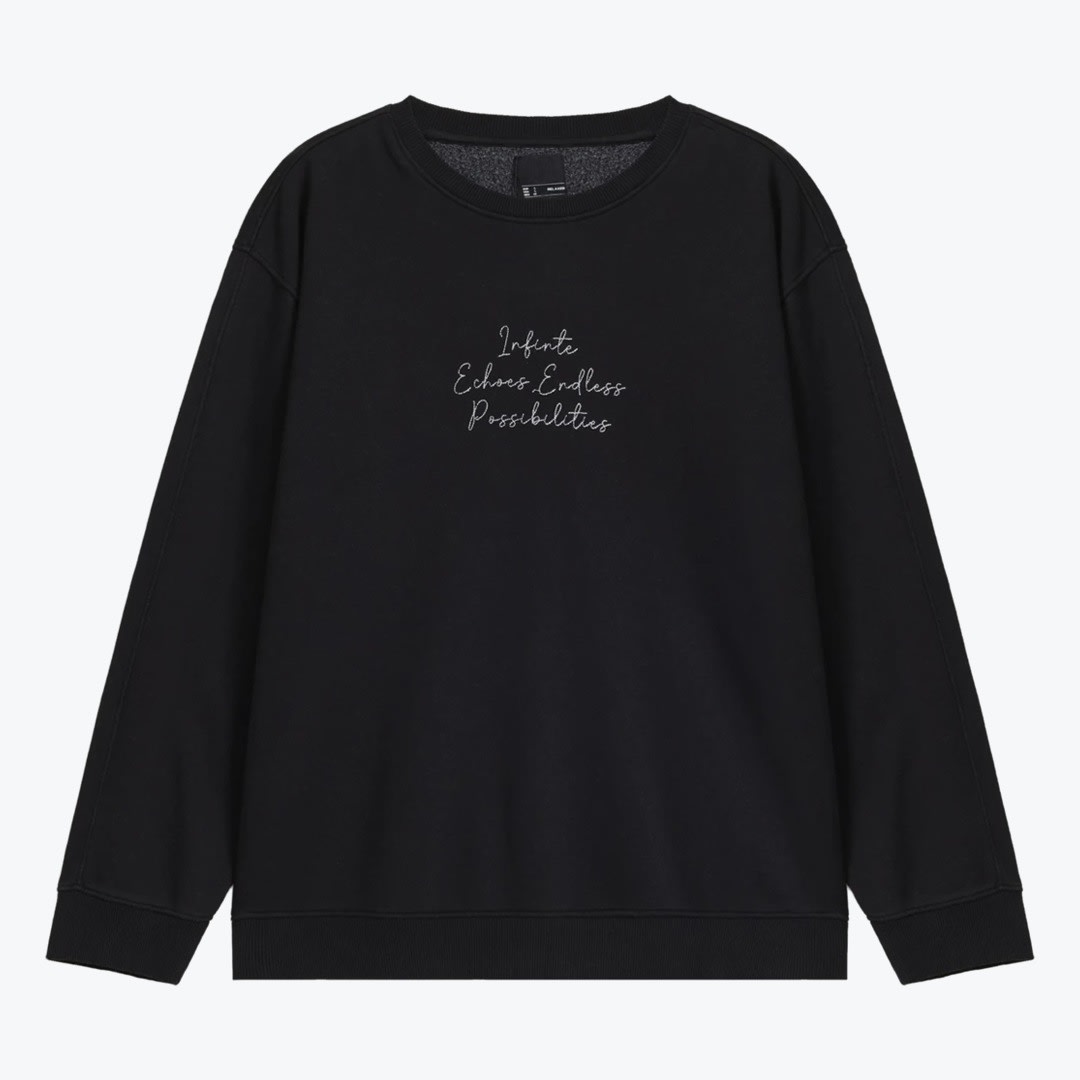Black Crewneck Sweatshirt with Cursive Script A flat lay of a black crewneck sweatshirt with white cursive text reading Infinte Echoes Endless Possibilities on the center chest, set against a plain white background.