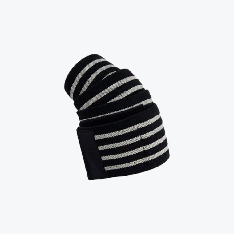 Black and White Striped Elastic Joint Support Wrap A rolled-up black elastic joint wrap with white stripes and a velcro strap on a solid white background.