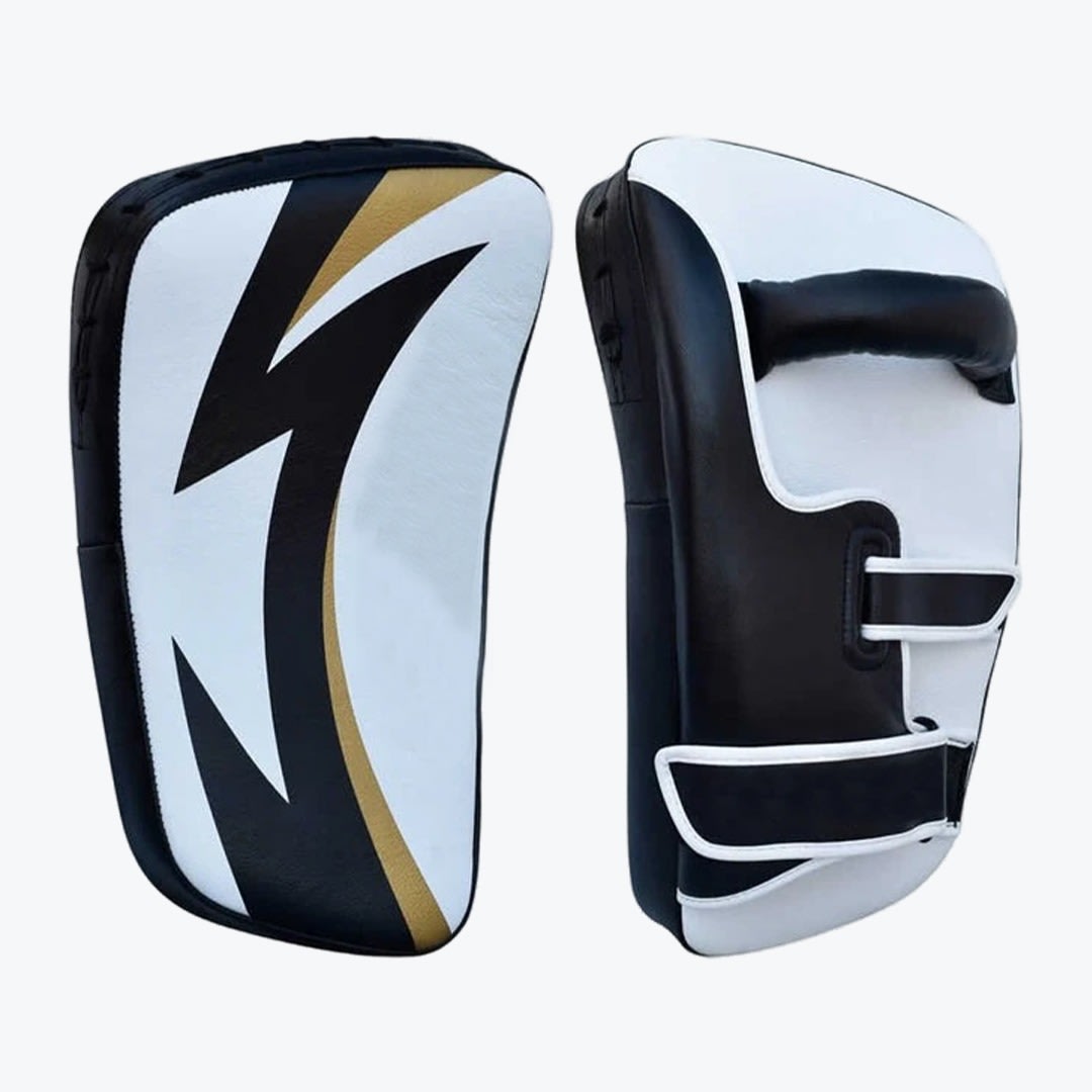 Professional Curved Thai Kick Pads in Black, White, and Gold Front and back view of a pair of black, white, and gold curved Thai kick pads used for martial arts training.