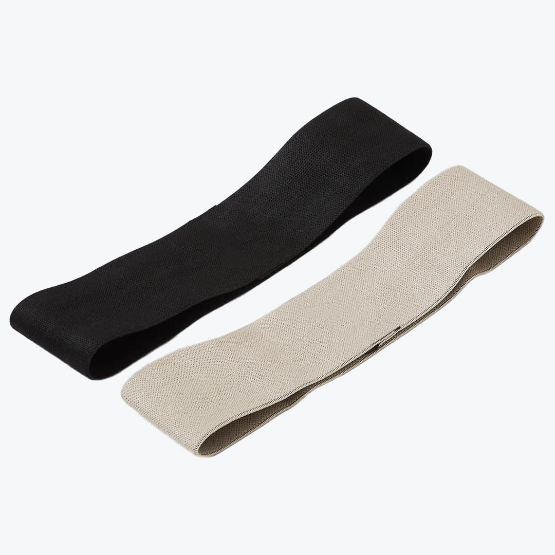 Fabric Resistance Bands Set Two fabric loop resistance bands, one black and one beige, arranged diagonally on a white background.