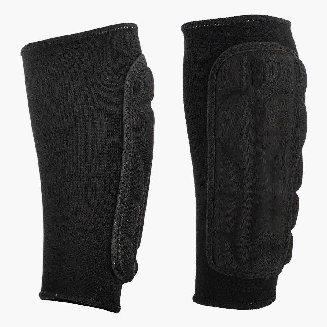 Black Padded Compression Shin Guards A pair of black padded compression sleeves shown against a white background, one from the side profile and one from the front, showcasing the segmented protective padding.