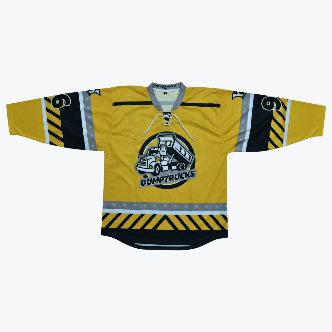 Dumptrucks Custom Hockey Jersey A yellow hockey jersey with a cartoon dump truck logo on the front, hazard stripes on the sleeves and hem, and the number 6 on the shoulders.