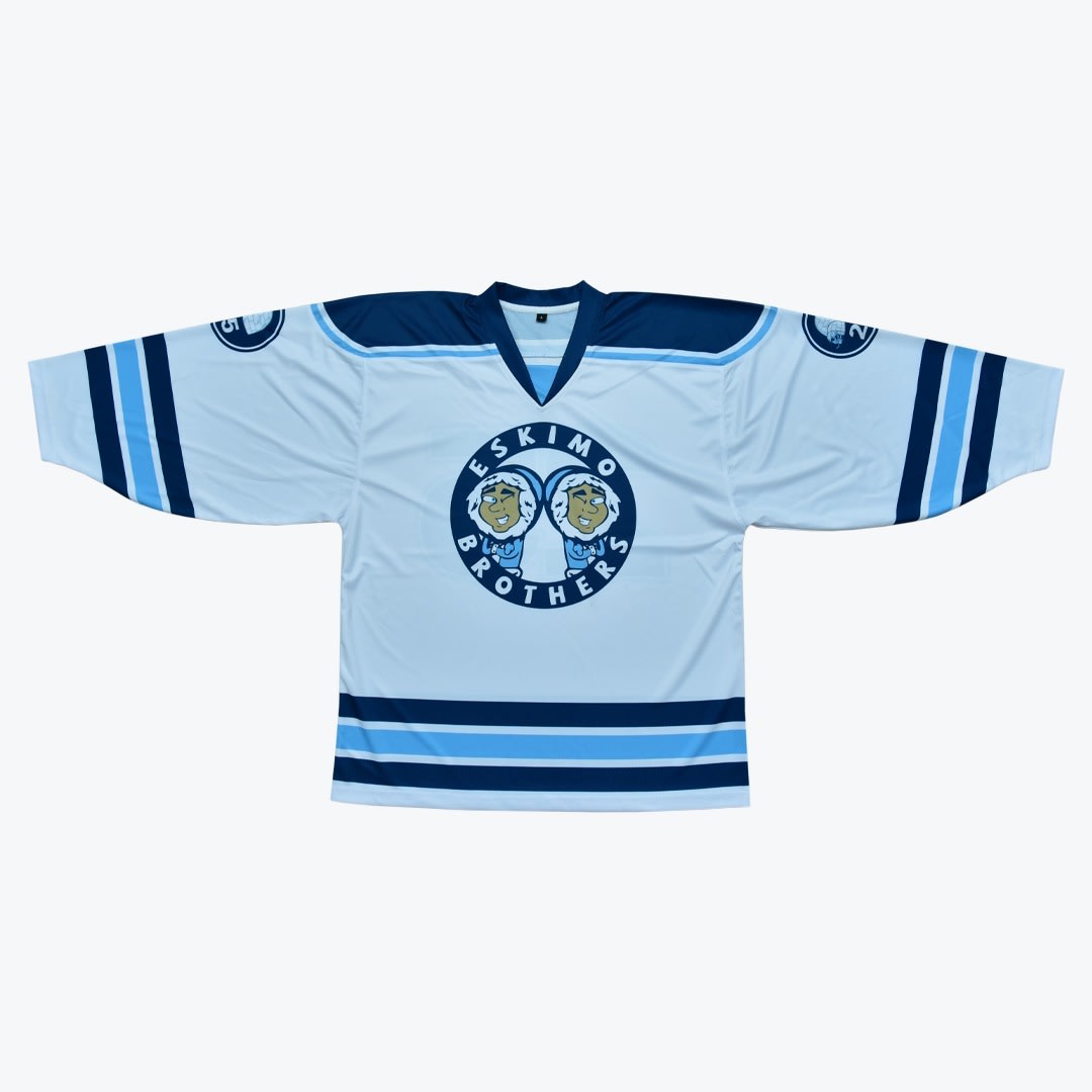 Eskimo Brothers Custom Hockey Jersey A light blue hockey jersey with dark blue stripes and a circular logo in the center that reads ESKIMO BROTHERS with two cartoon characters.