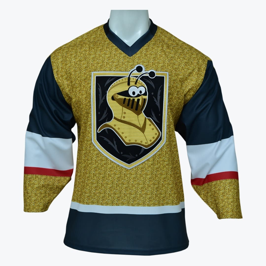 Custom Gold and Blue Hockey Jersey with Cartoon Knight Mascot A gold, dark blue, white, and red hockey jersey featuring a cartoon mascot wearing a knight's helmet on a shield logo.