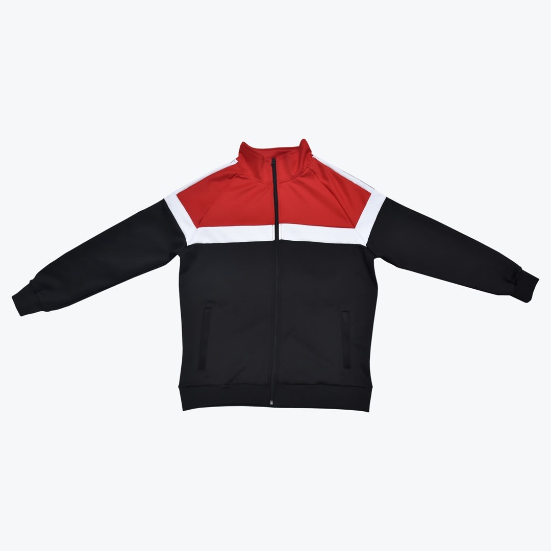 A red, white, and black color-blocked track jacket with a full zipper, laid flat on a white background.