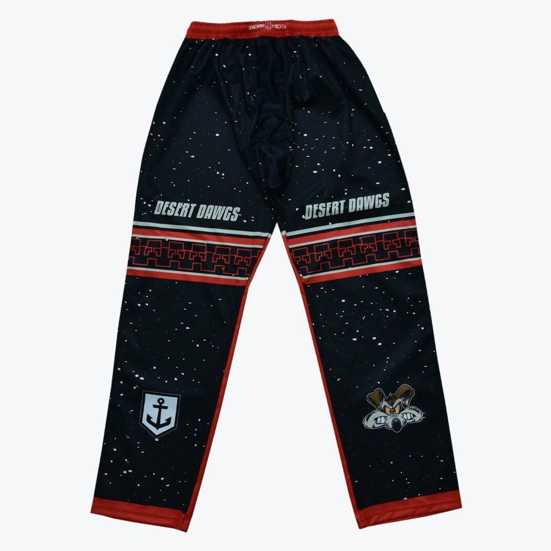 Anchor Hockey Desert Dawgs Athletic Pants Black athletic pants with Desert Dawgs text, a red geometric stripe, an anchor logo, and a cartoon coyote mascot on a white background.