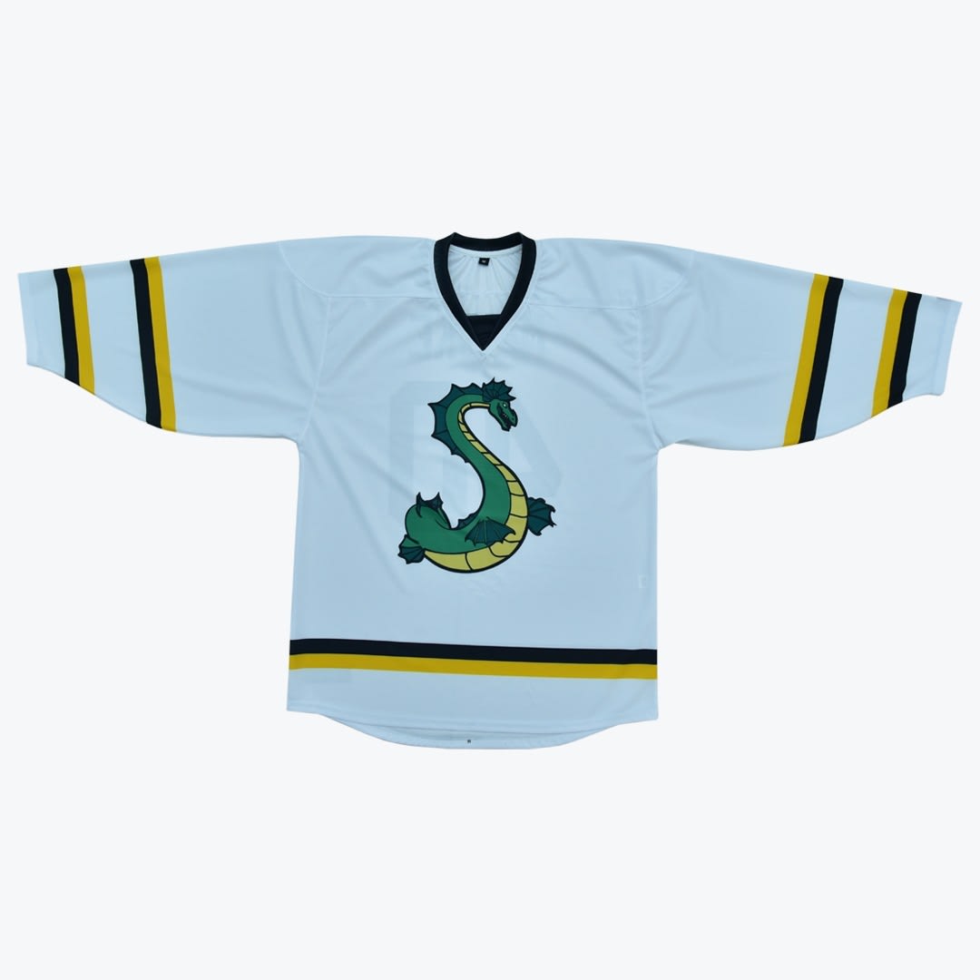 Light Blue Sea Serpent Hockey Jersey A flat lay of a light blue hockey jersey with a green sea serpent logo shaped like the letter S on the chest, detailed with black and gold stripes on the sleeves and hem.