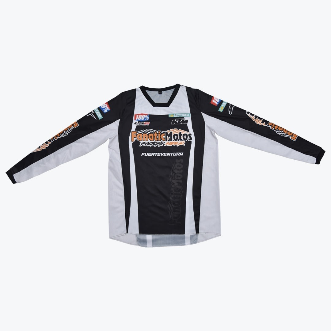 FanaticMotos Fuerteventura Motocross Jersey A black and white long-sleeved motocross jersey with FanaticMotos and Fuerteventura branding, displayed flat against a white background.