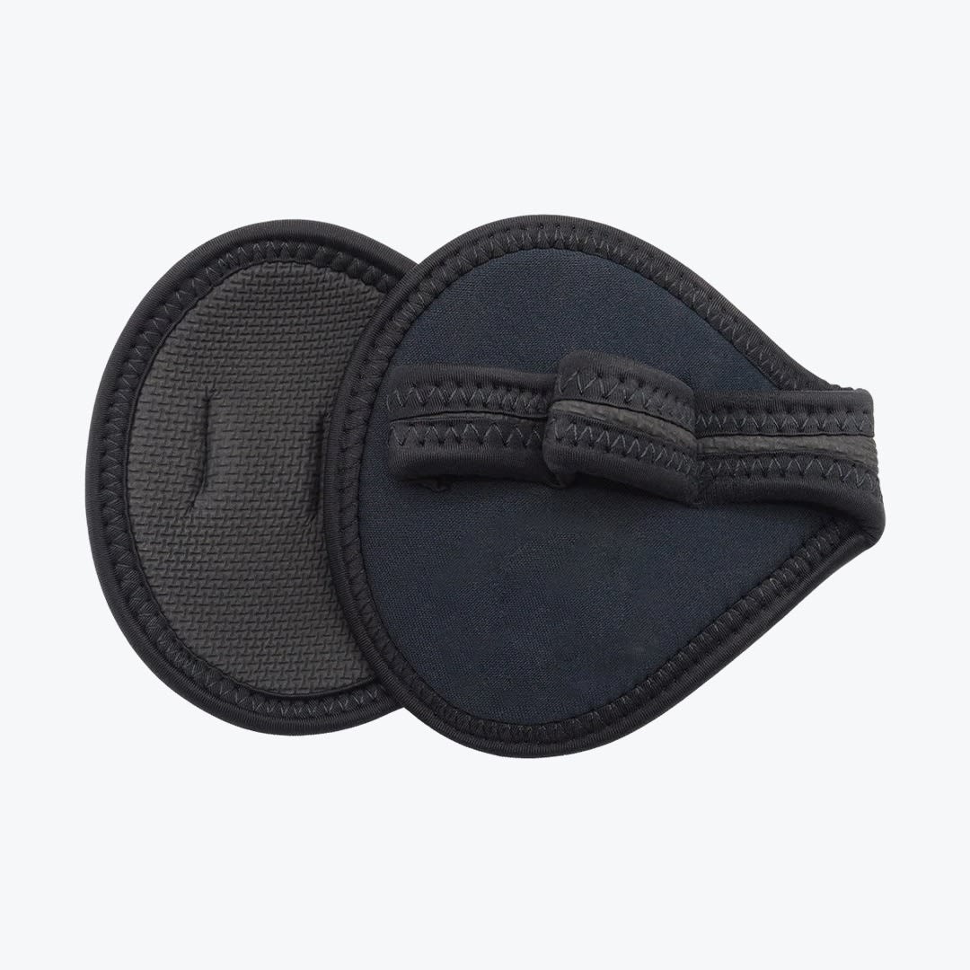 Two black neoprene gym grip pads on a white background, showing both the textured palm side and the back side with a finger strap.