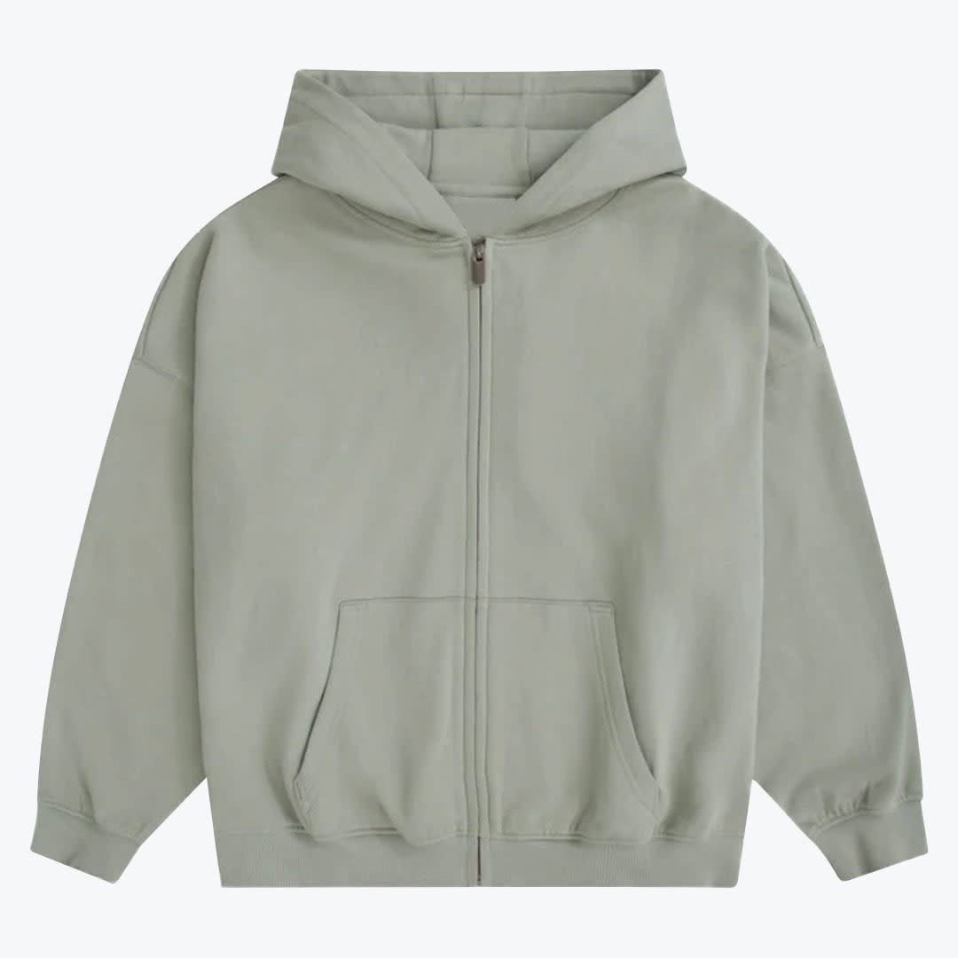 Sage Green Zip-Up Hoodie A light sage green zip-up hoodie with a hood, front zipper, and kangaroo pockets, displayed against a plain white background.