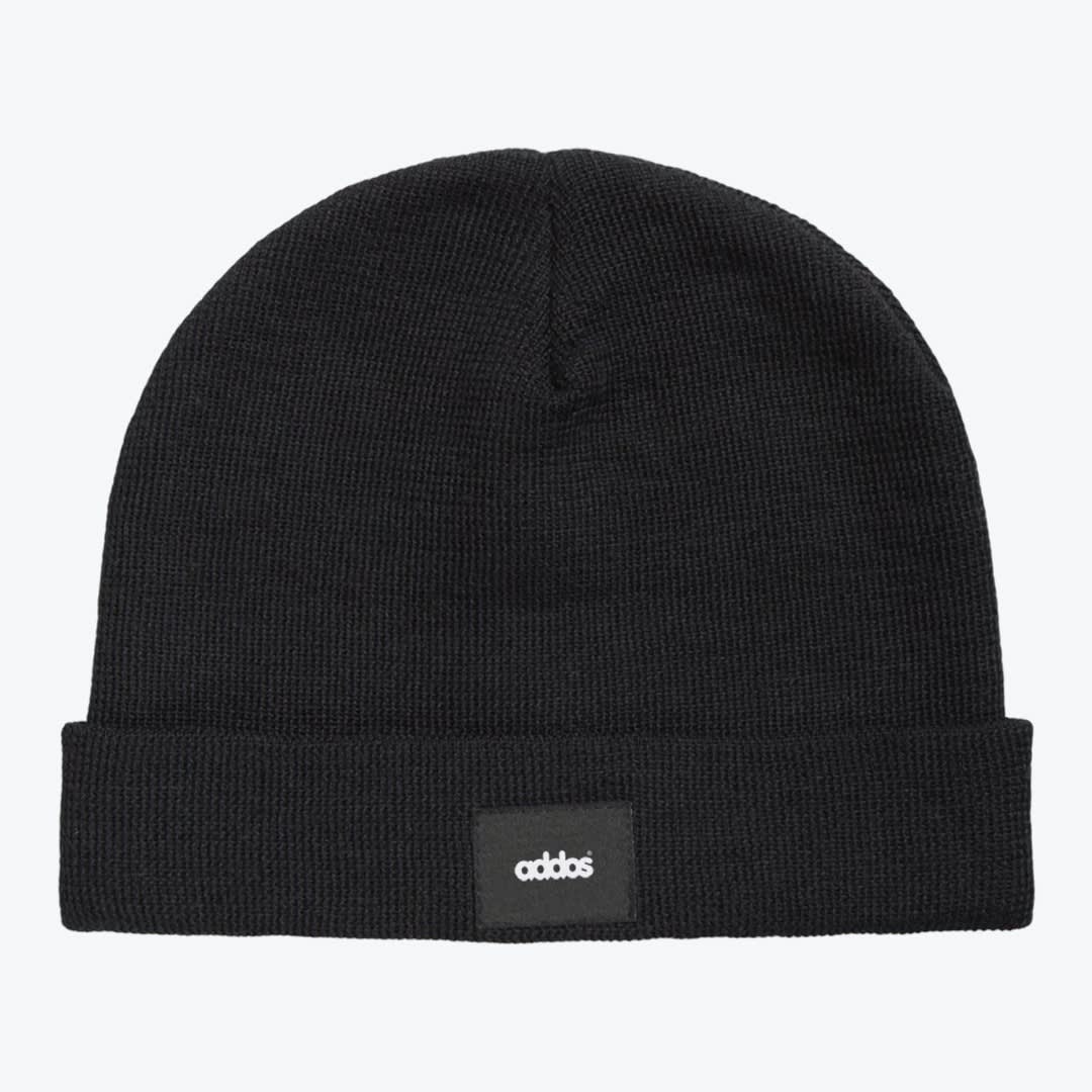 Black Addos Knit Beanie A black knit beanie with a folded cuff and a small black patch displaying the word addos in white text, set against a plain light background.