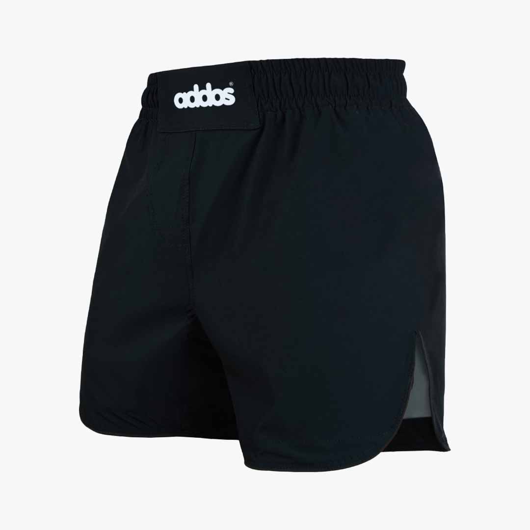 Black Athletic Boxing Shorts with Elastic Waistband A pair of black boxing shorts with a thick elastic waistband and a white addos logo patch, shown from a three-quarter angle on a white background.