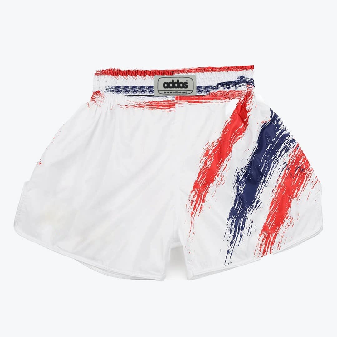 White Muay Thai Shorts with Red and Blue Brushstroke Design A pair of white Muay Thai shorts with red and blue brushstroke designs on the left side and waistband, featuring an addos brand label in the center.