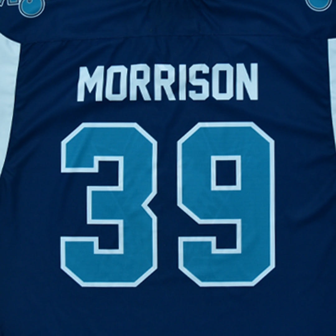 The back of a dark blue jersey with MORRISON in white letters and a number in teal with a white border.