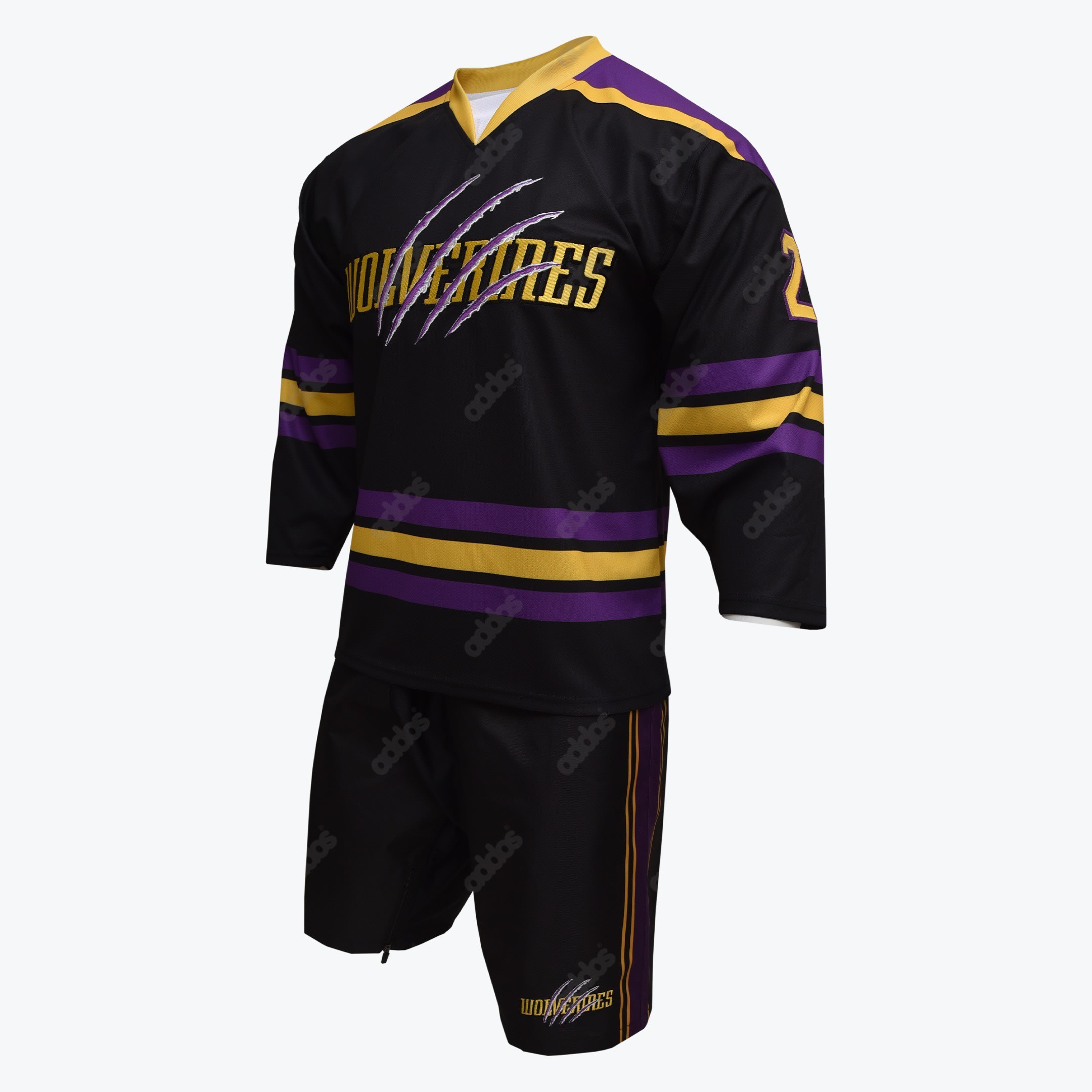 A black short-sleeve sports jersey and matching shorts set with purple and gold stripes, featuring the word WOLVERINES with claw mark graphics and the number 23 on the chest, displayed on a white mannequin against a plain white background.